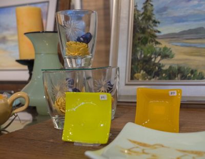 Sandpiper platter by Bob Heath, petite glass by Rox Heath, hand-cut motif glasses, hand-made ceramic bowl by Marcia Hudson, watercolor and oil by Paul Brent, and hand-wrapped butterscotch (for fun).
