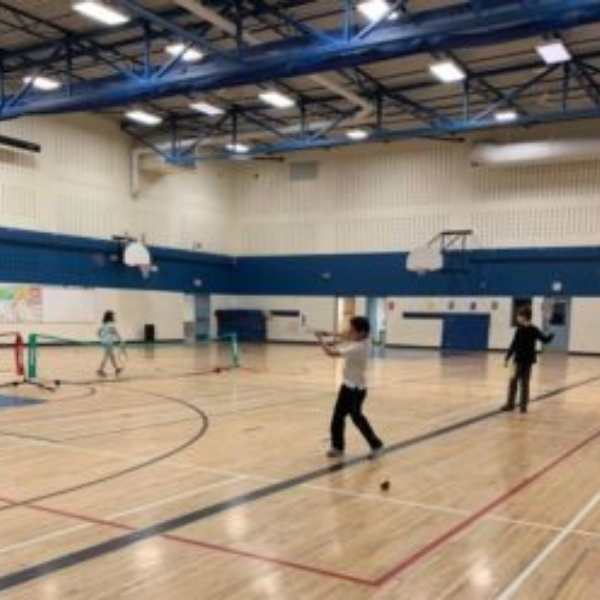 Arthur is having fun and also learning how to play tennis at the First Serve Tennis