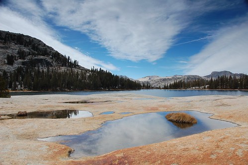 Photo: Lower Cathedral Lake and puddles in granite reflecting clouds. Photo by Tyler Westcott