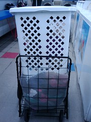 Then you have to fit both the laundry basket and the big mesh bag into your hand cart.
