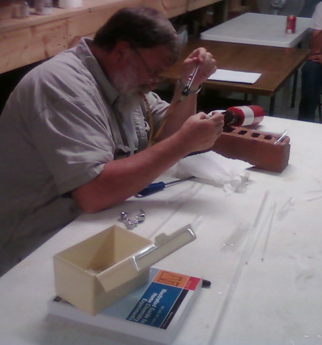 John building a tee connection in two glass tubes.
