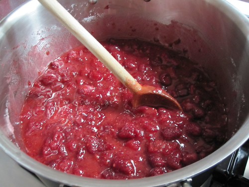 Heated raspberries and sugar and lemon