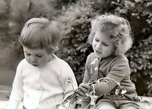 I've had a bad day there's no making up to me for it. Me as a toddler looking sad with my Aunt Susan also a child offering me flowers
