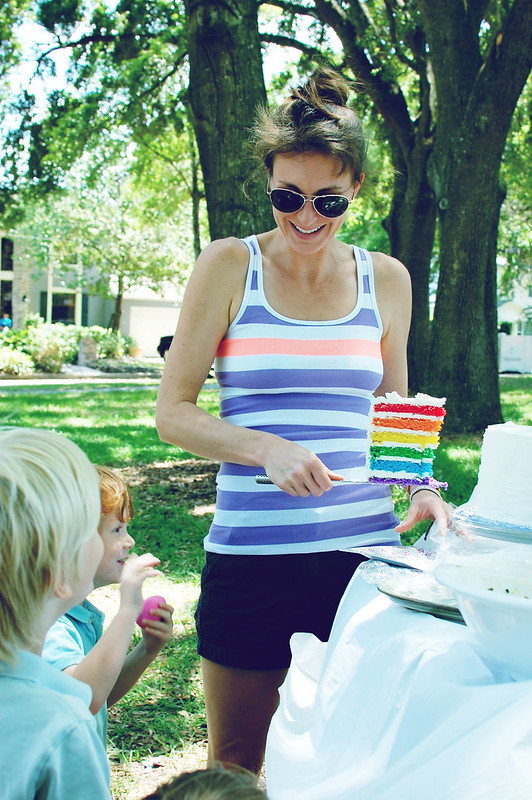cutting into rainbow cake