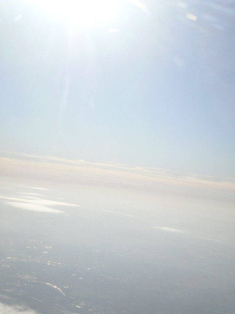 Looking forward hoping for a bright future Sunlight on clouds taken from an airplane window