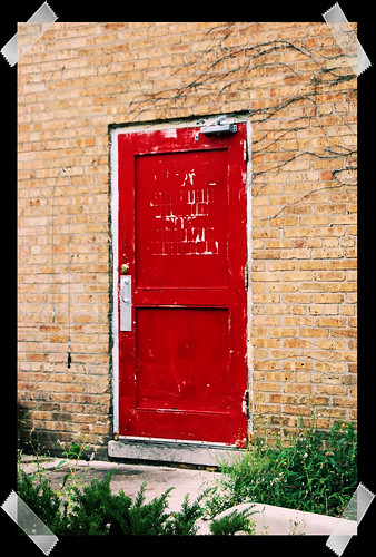 red door - photo treated to look as if taped onto black paper