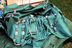 Paula's jewelry displayed on green satin