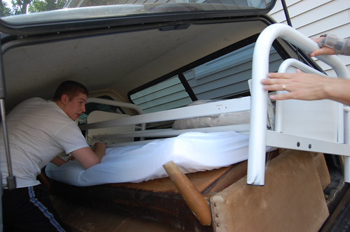 Aaron in truck helping pull in frame of futon