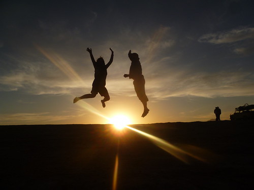 Jumping over the sun as it sets over the desert P1090435