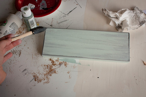 Add black paint on edges and watered down paint for a distressed look