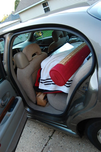 Door open to show packed back seat of Aaron's car