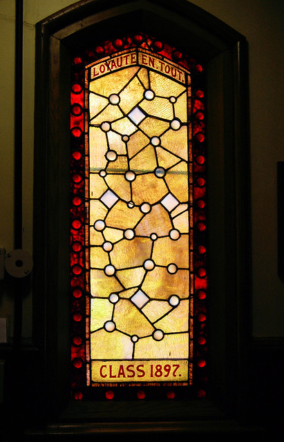An abstract design of circles and angles in red and gold. 