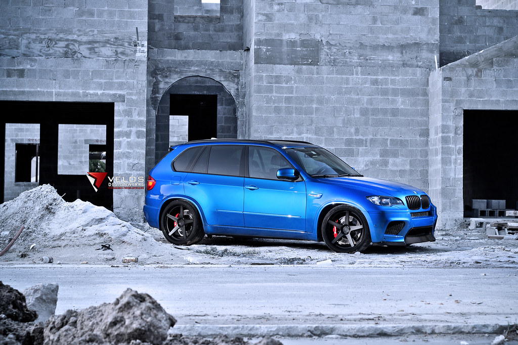 A blue bmw x5m with a lot of upgrades built by velos designwerks