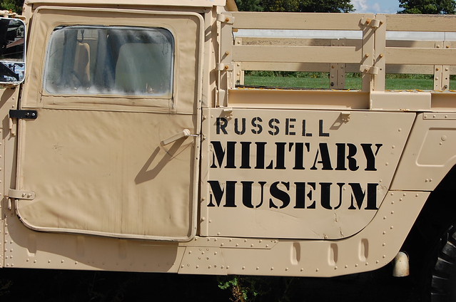 Army truck painted desert brown with the words stenciled in black on the side