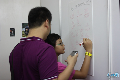 A visitor is putting her signature in the Guest Signature Board