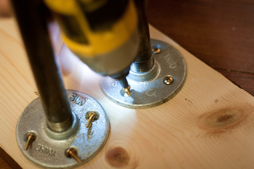 Attach the flanges to the bottom of the table top