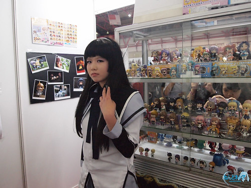 A cosplayer posing inside the booth