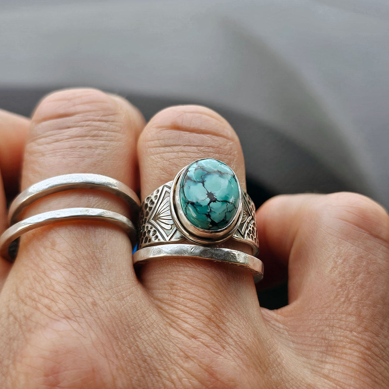 This turquoise ring, worn with small stacking bands of silver.