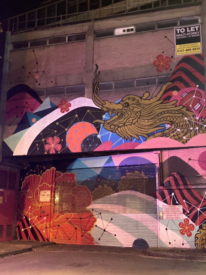 Oriental street art including a Chinese dragon and a red camellia.