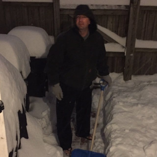 Alaskan native Isaac Edwards shoveling snow in flip flops. "This snow isn't much compared to Alaska." (Photo: Kelli Edwards)