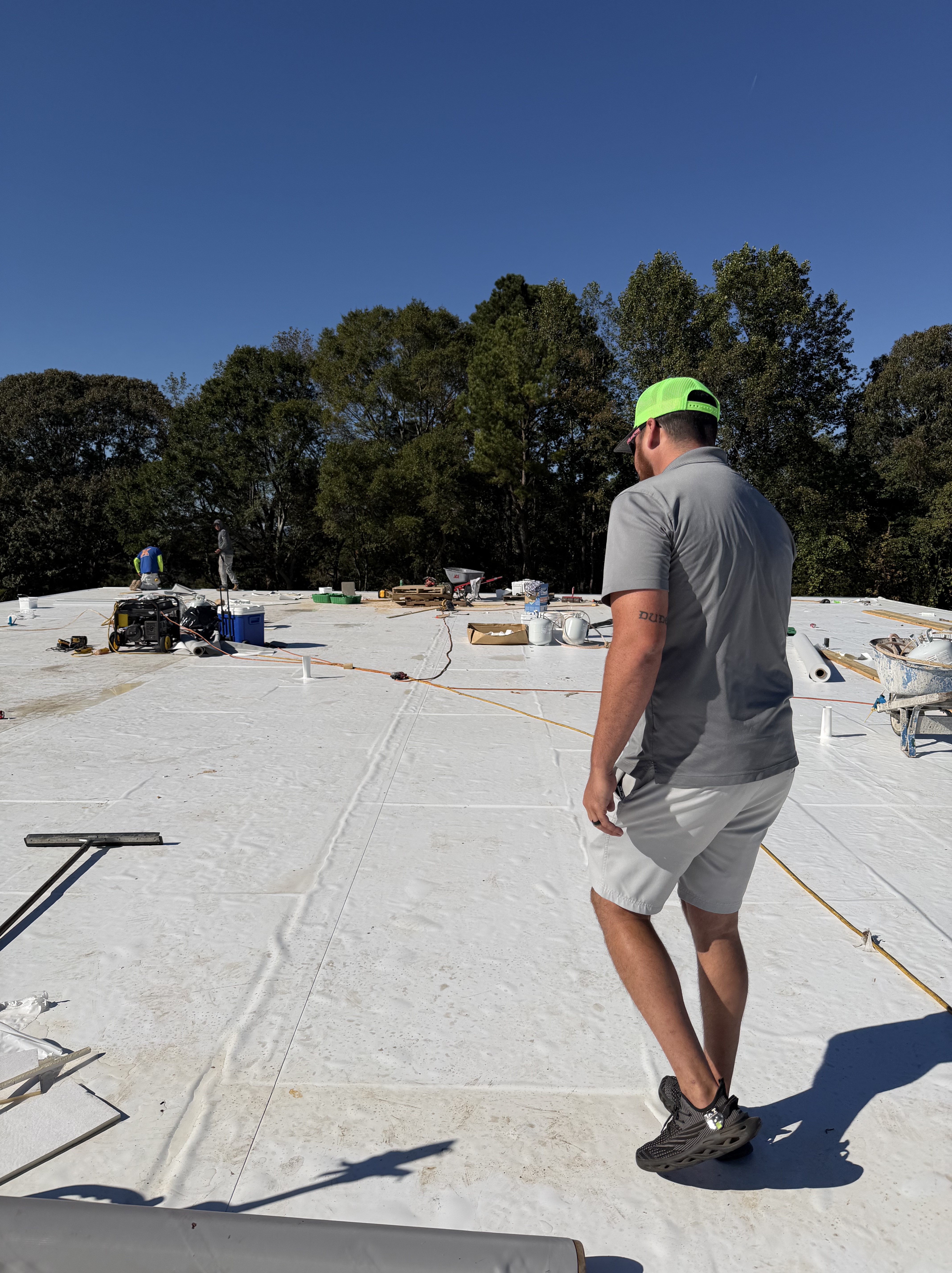 First Class Roofing crew on a large commercial roof