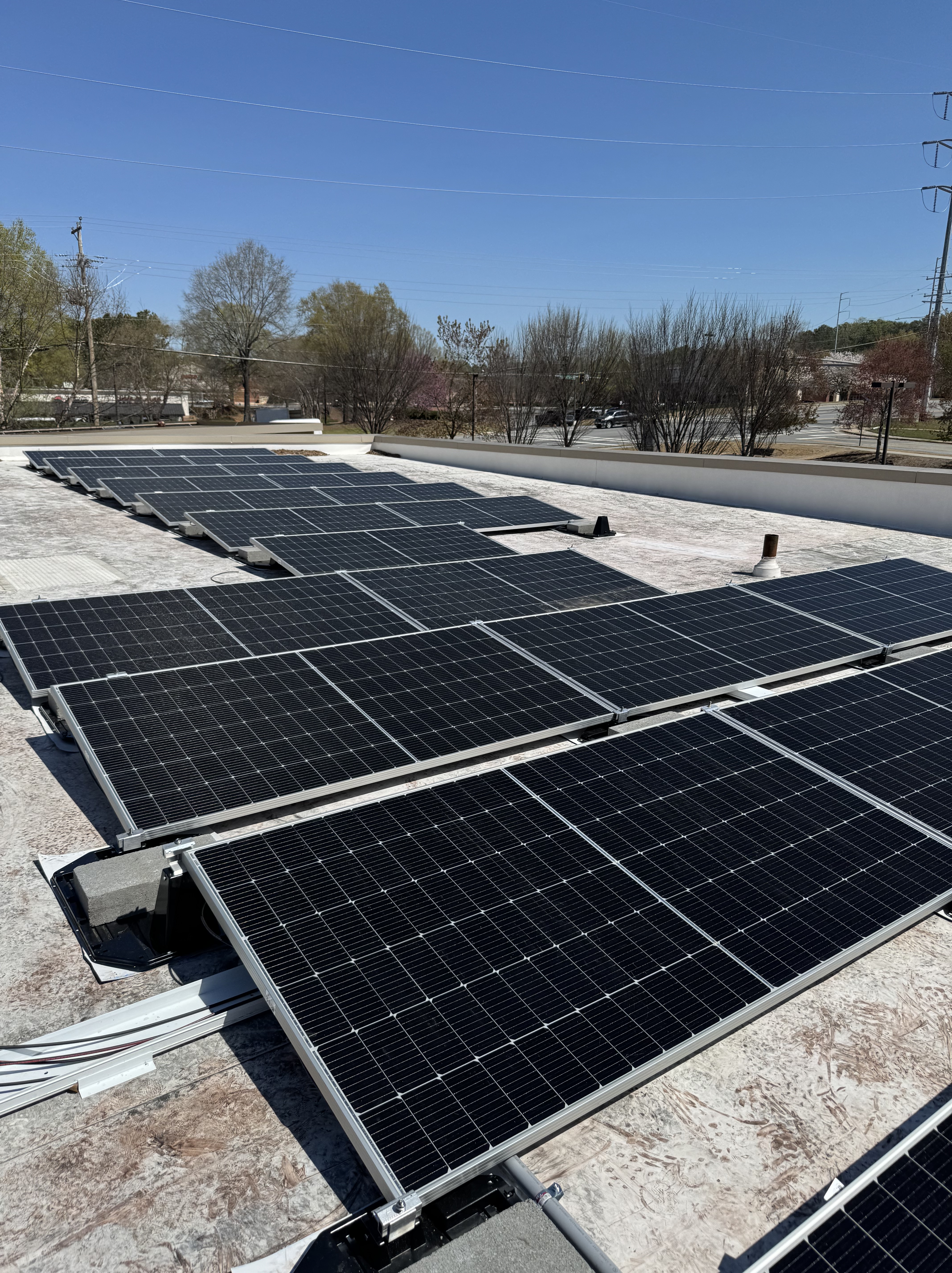 Solar panels installed on a roof by First Class Roofing