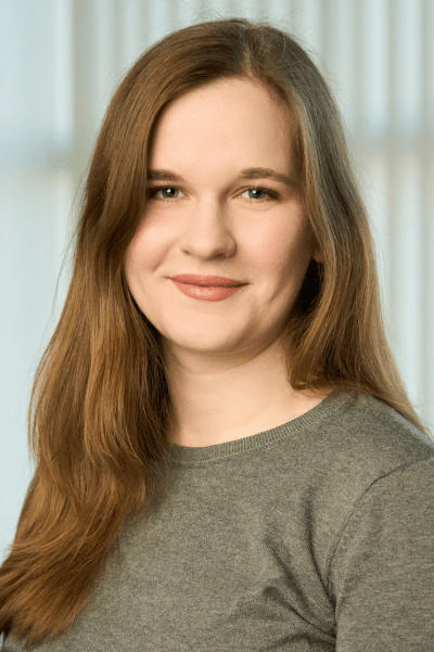 A headshot of Emma smiling at the camera.