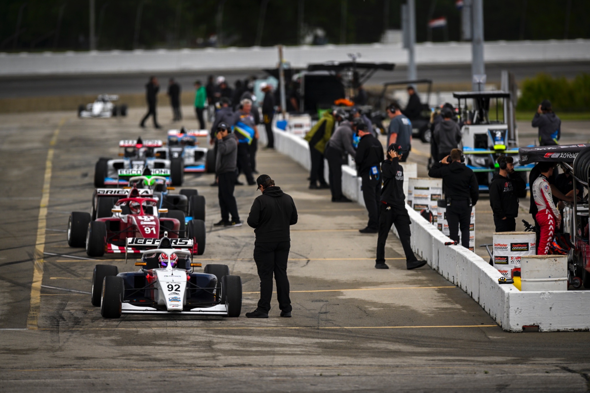 Junior single-seater cars racing on track.