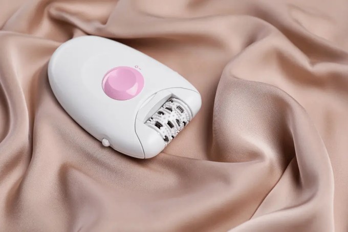 Femboy epilator sitting on a blanket