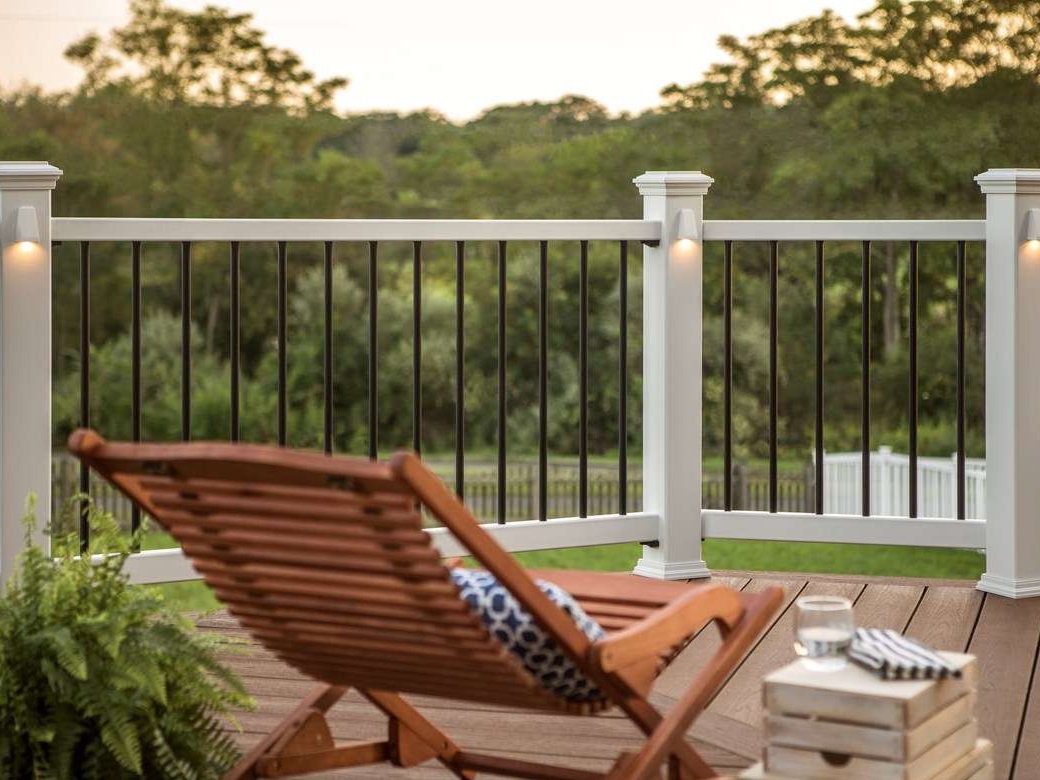 A Trex Transcend railing in the background on a deck at twilight