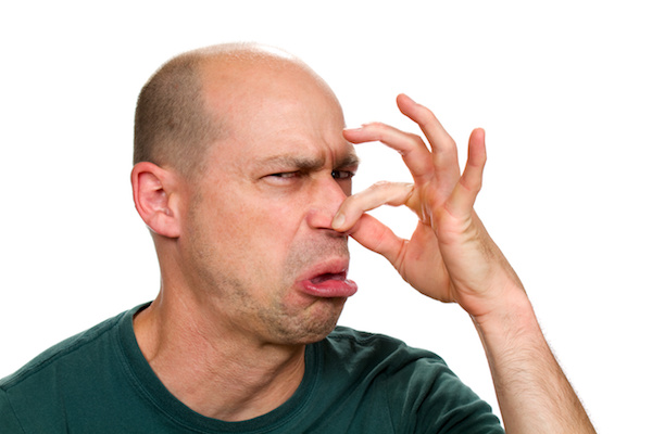 Stock photo of a man pinching his nose.
