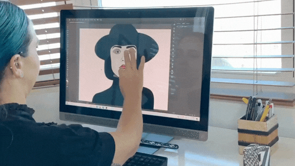 A graphic designer working a fashion poster