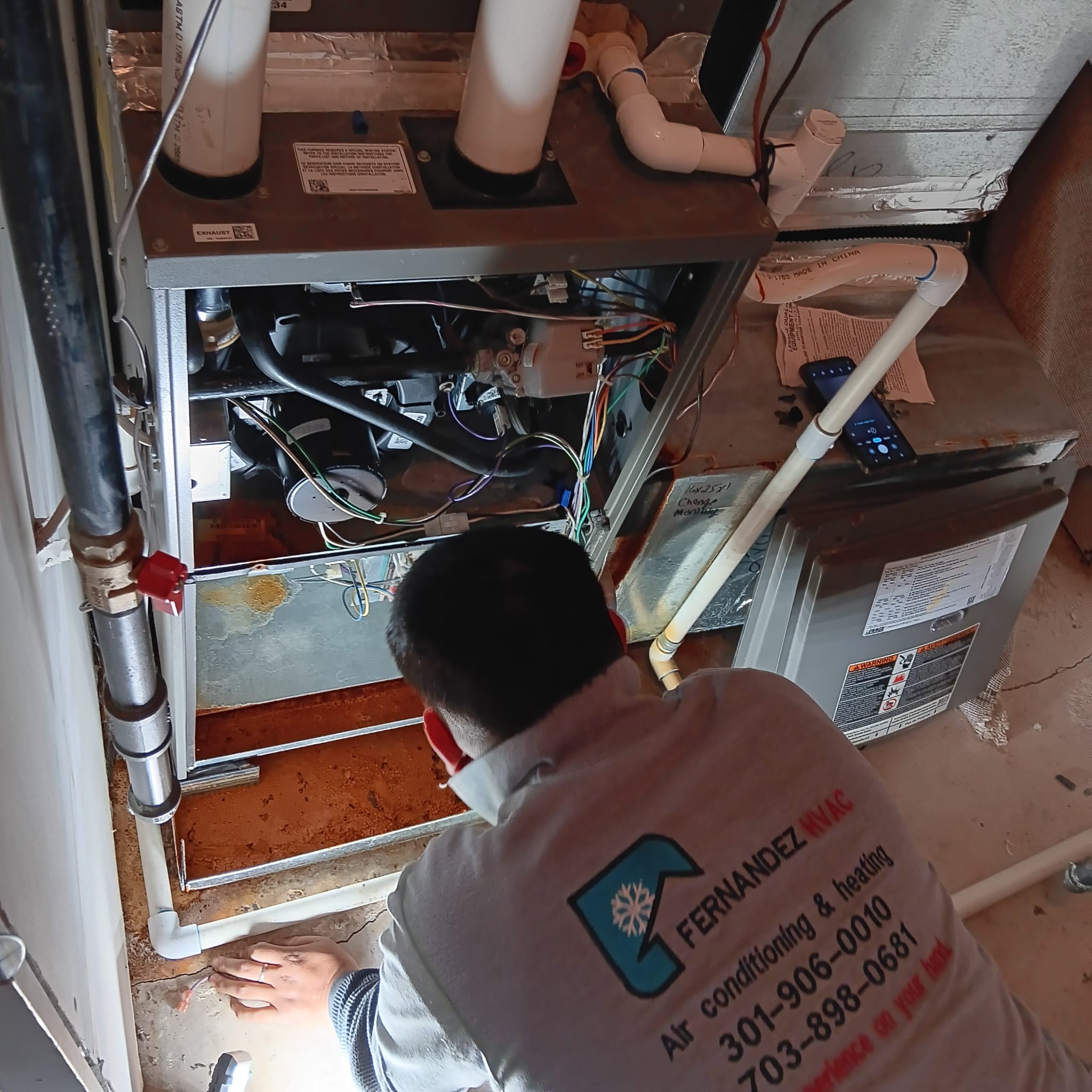 HVAC technician inspecting a residential heating system.
