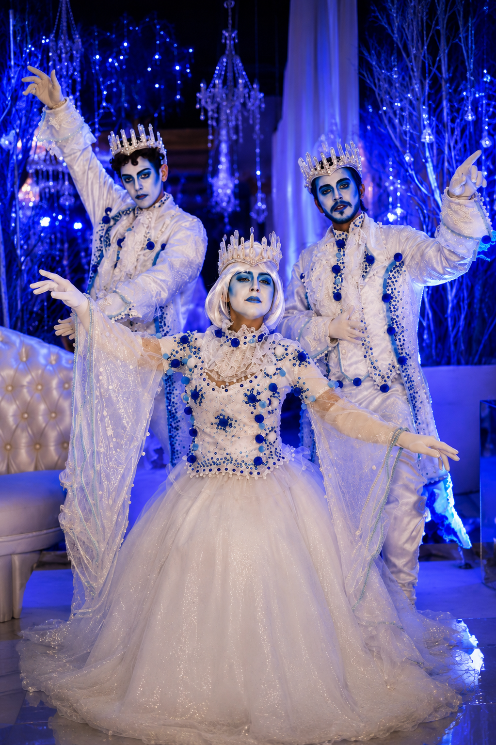 Performers in an icy blue celebration setting