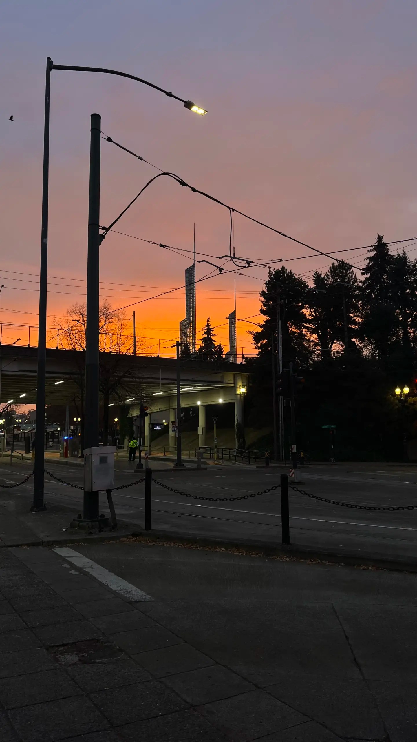 Photo of a sunrise over the Oregon Convention Center as seen from Rose Quarter.