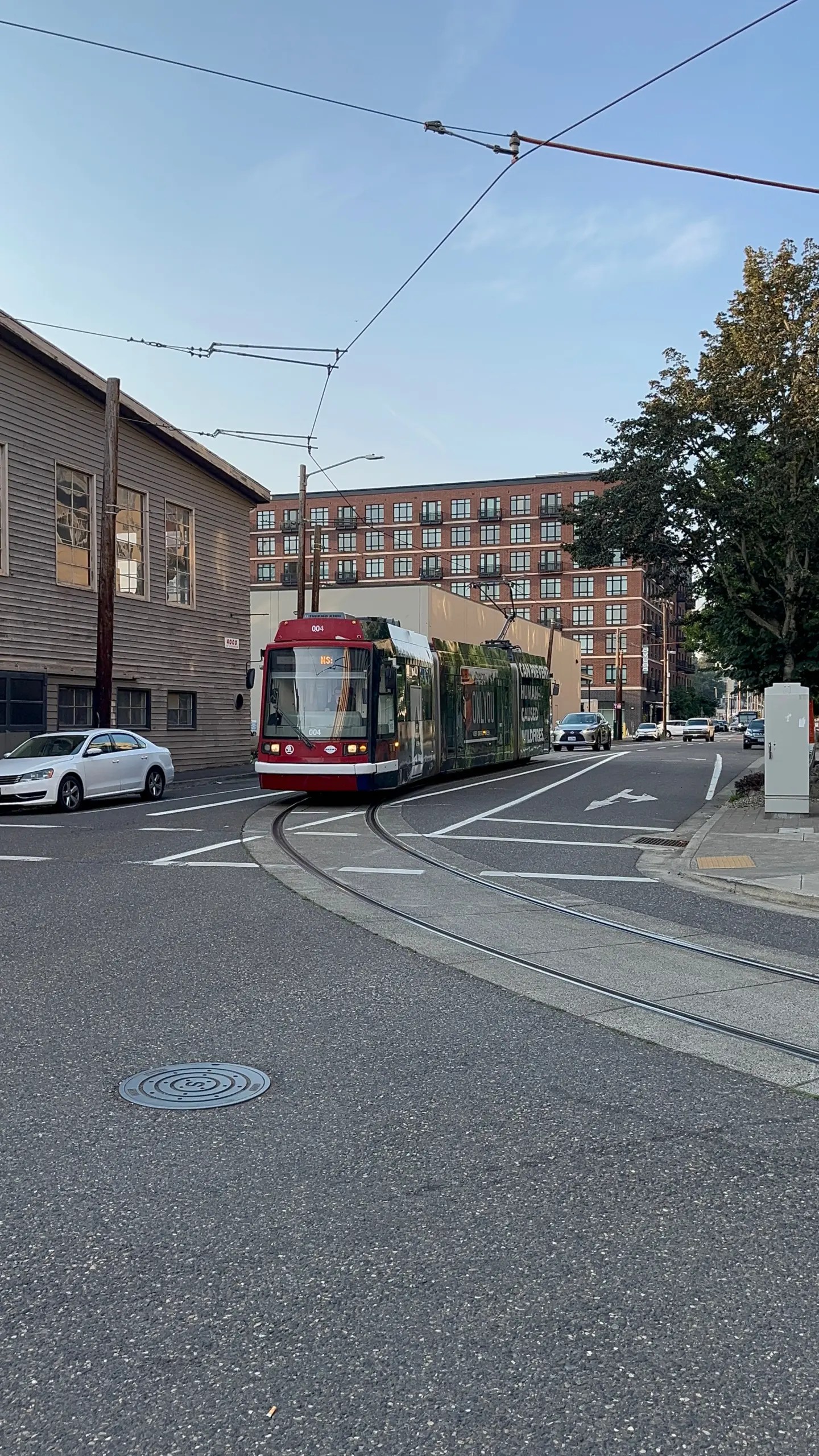 Portland Streetcar 004 arrives at S Lowell & Bond as the first refurbished car in the fleet.