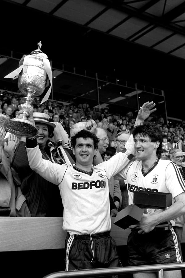 Steve Foster lifts the league cup trophy in 1988 with Mick Harford