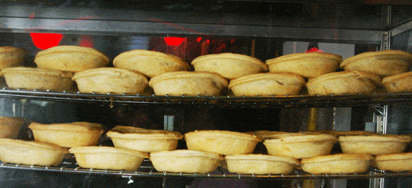 pies on display at a soccer bar
