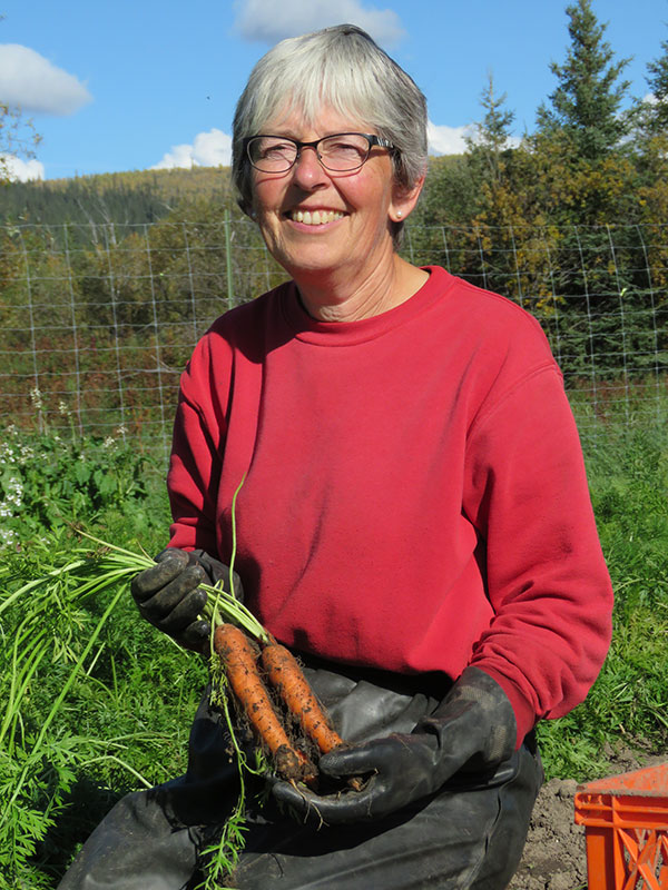 Lucy Vogt and carrots. From FirstWeEat.ca, the Food Security North of 60 website supporting First We Eat, a documentary by Yukon filmmaker Suzanne Crocker about eating only locally-grown foods in in Dawson City, Yukon, in Canada's North, for one year.