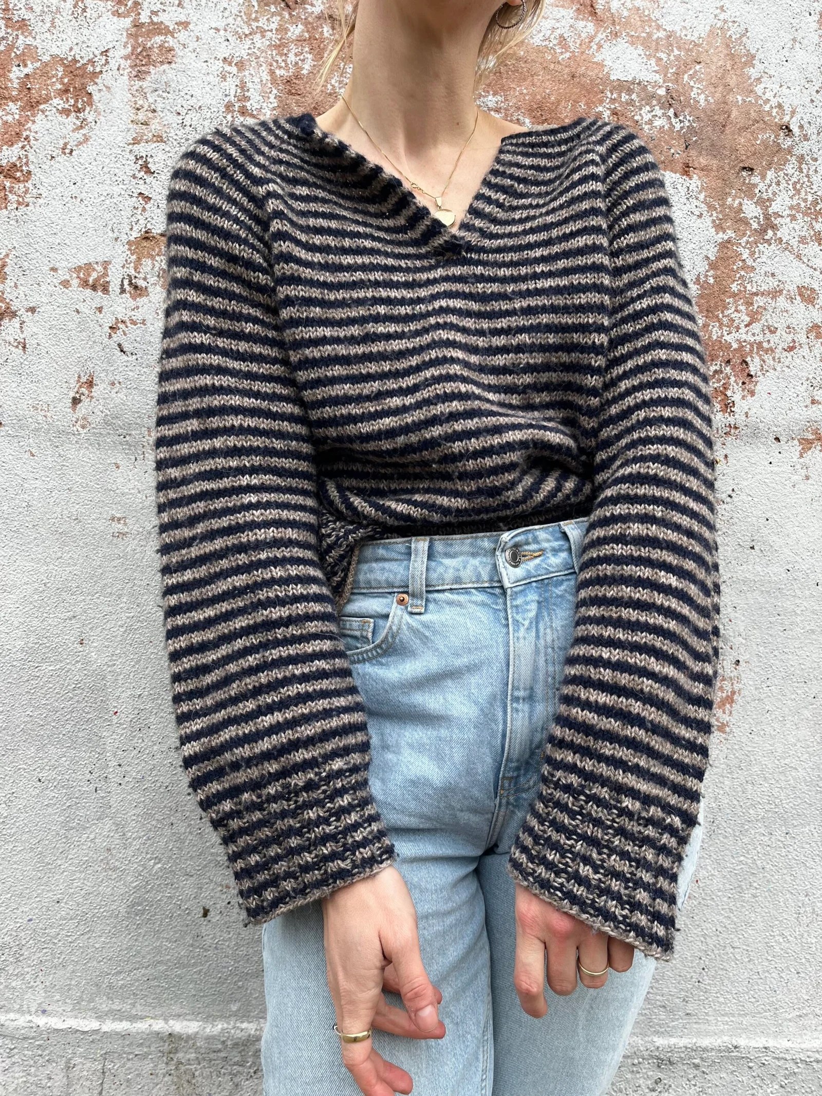 Product image for Rockfish Sweater knitting pattern — Soft, hand-knit pullover in dark colors with subtle horizontal striping and relaxed, loose-fit silhouette.