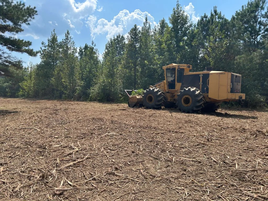 Commercial land clearing equipment working on a development site in Mississippi