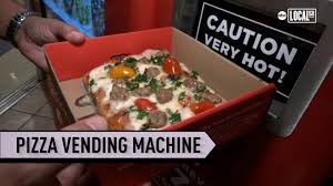 A self-serve fresh pizza vending machine serving hot, delicious pizza 24/7 in a university cafeteria.