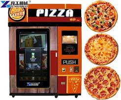 Students enjoying pizza from a self-serve fresh pizza vending machine, placed in a campus common area for 24/7 food access.