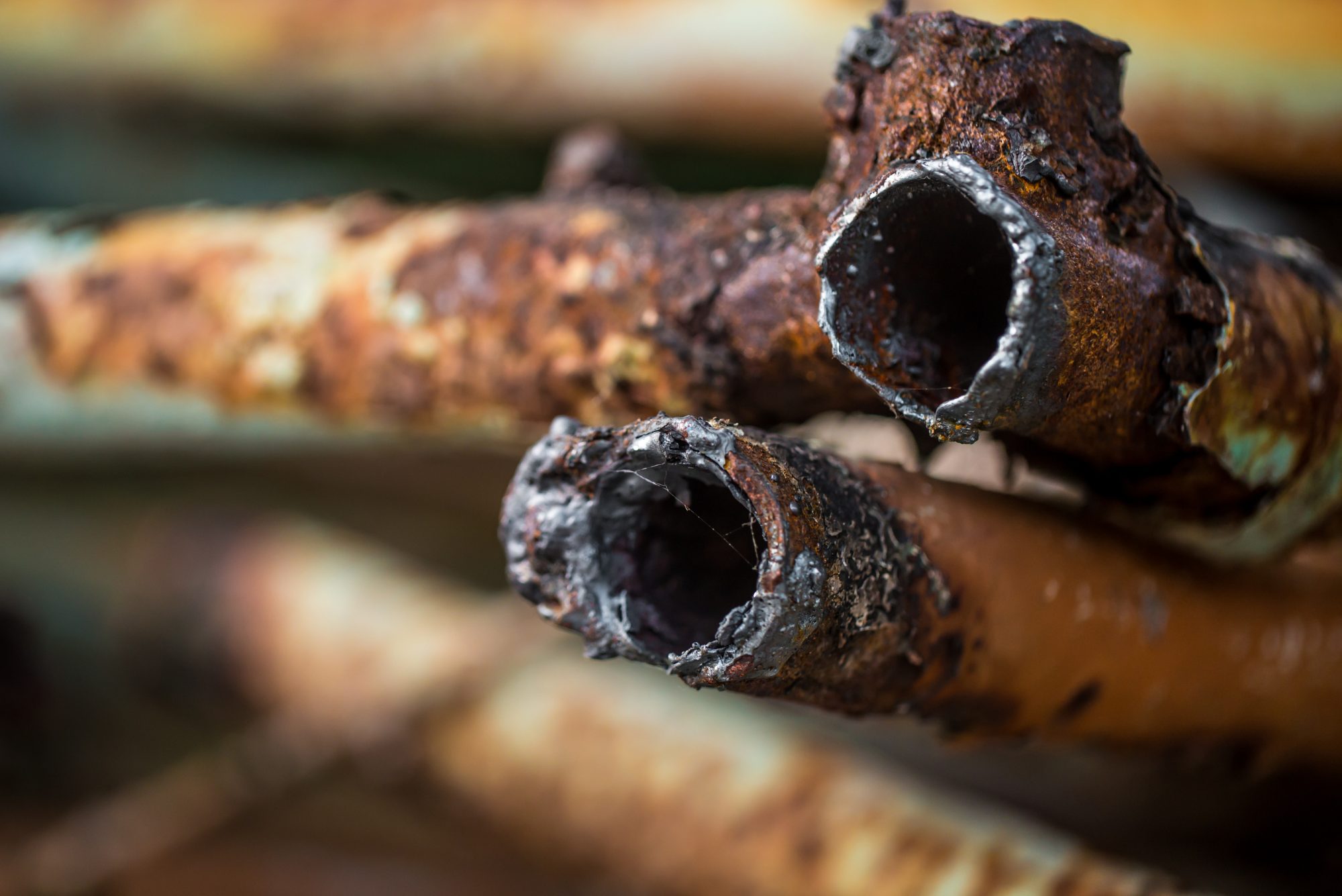 Corroded metal pipes with rust and deterioration, highlighting issues related to pipe repair in Jackson, GA.