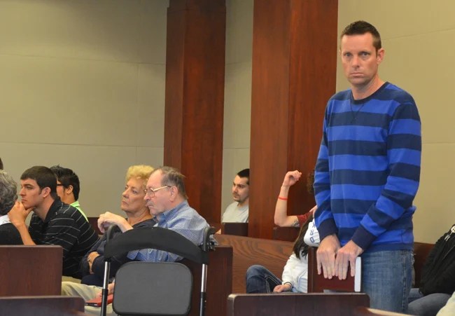 Daniel Biles, in court this afternoon, held--and read--the Bible as he waited his turn. (c FlaglerLive)