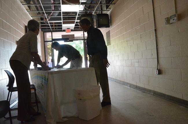 Several dozen people turned out at a county-hosted open house Friday at the old Flagler County Courthouse. To be safe, they signed in--so the county could ensure that all had exited the structure when it was shut down again. (© FlaglerLive)