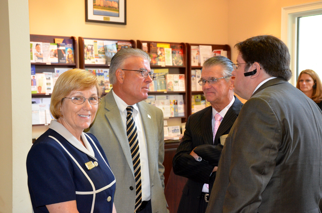 small-cities Emerging markets: from left, Bunnell Mayor Catherine Robinson, Flagler Beach Manager-in-Waiting Bruce Campbell, Flagler Beach City Commission Chairman John Feind, and possibly outgoing Bunnell City Manager Armando Martinez. They were chatting after an hour with Gov. Rick Scott at the chamber of commerce last week. (© FlaglerLive)