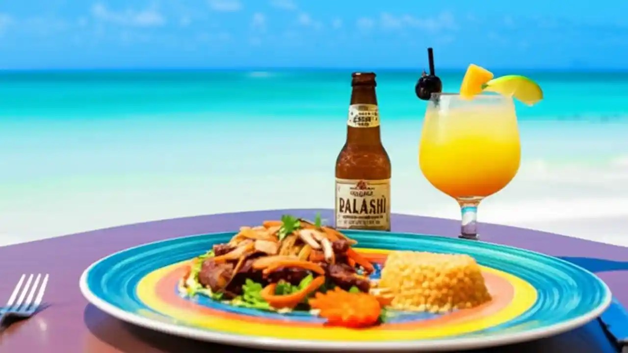 A table with food and drinks on a beach in Aruba, illustrating the cost of dining on the island.