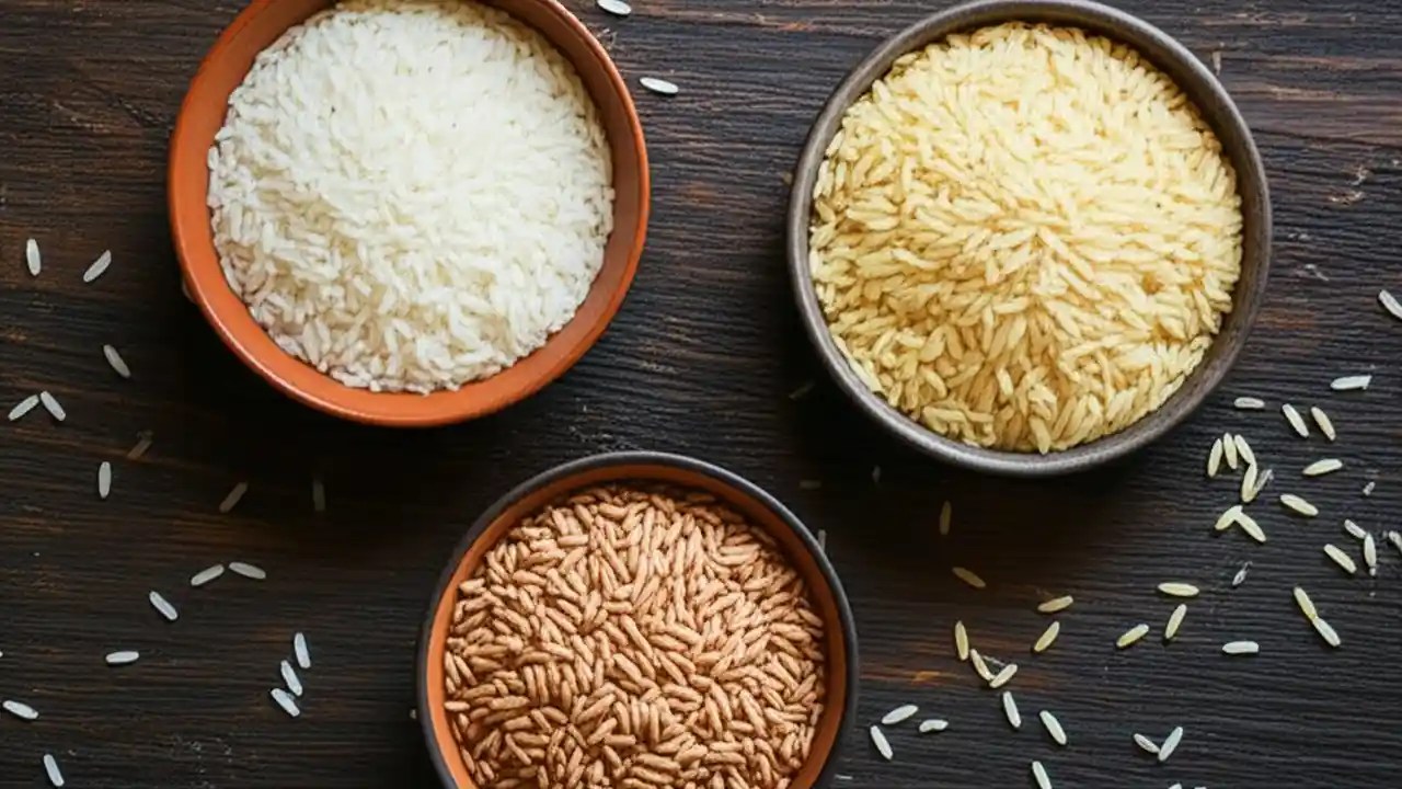 A close-up shot of a white bowl filled with perfectly cooked, separate, long grains of basmati rice, ready to be eaten.