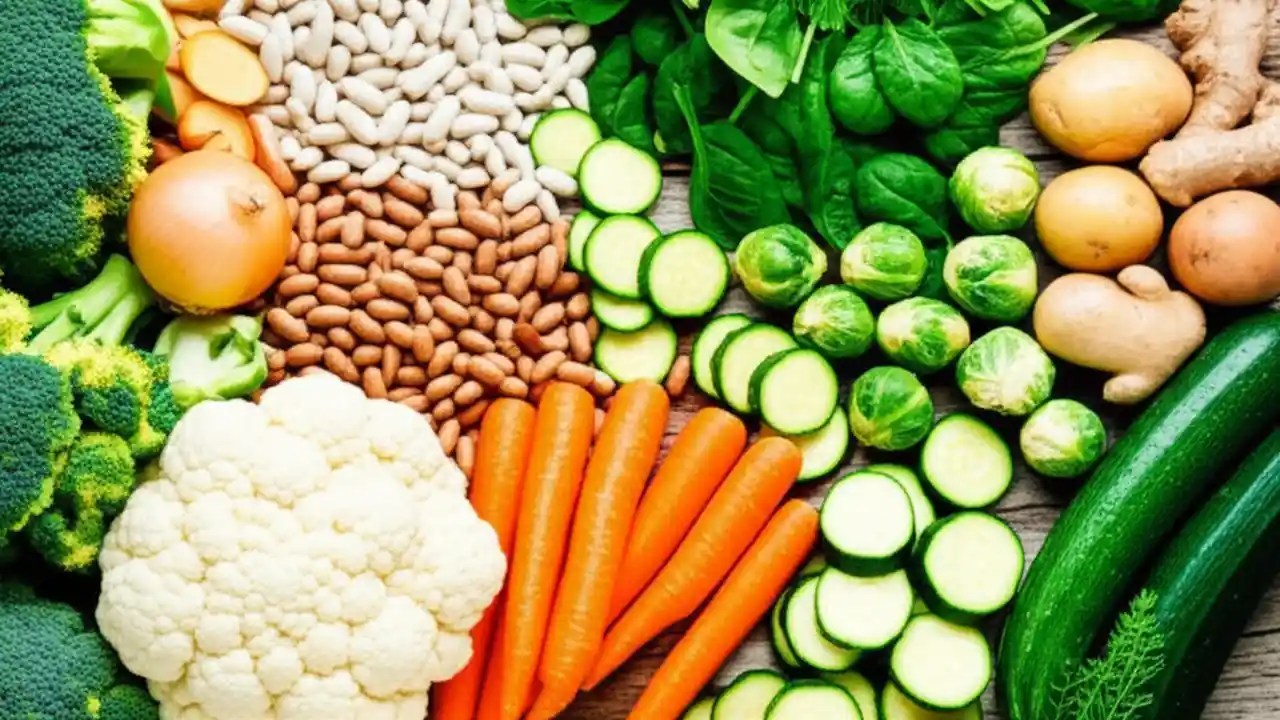 A flat lay showing gas-causing vegetables (broccoli, beans) alongside non-gassy ones (carrots, spinach), highlighting digestive comfort.